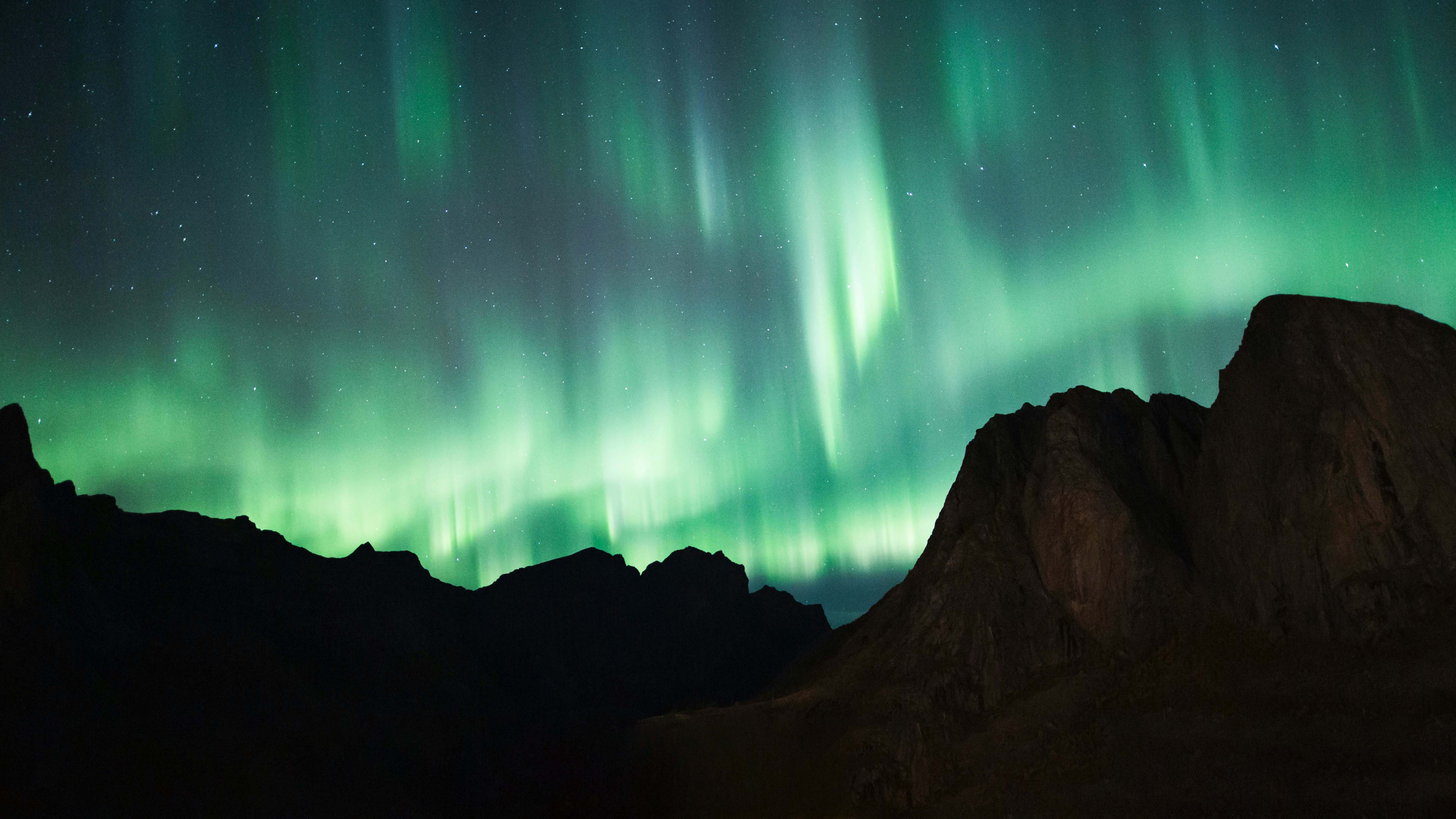 Aurora borealis over Nordic mountains and fjord